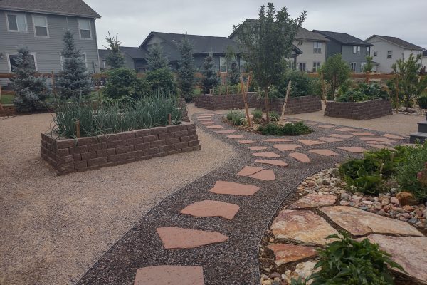 flagstone path leads to block raised vegetable gardens