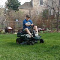 man on riding lawn mower